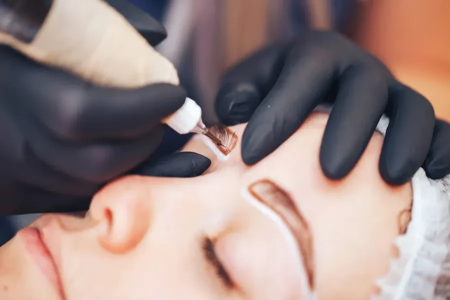 Permanent makeup brows being applied